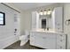 Renovated bathroom with a marble tile shower, custom cabinetry, and a modern vanity at 1342 S Andes St, Aurora, CO 80017