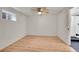 Bedroom features light wood floors, a modern ceiling fan, and an en-suite bathroom at 1342 S Andes St, Aurora, CO 80017