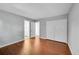 Spacious bedroom with hardwood floors, neutral walls, closet, and open doorway to another room at 1342 S Andes St, Aurora, CO 80017