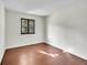 Bright bedroom with hardwood floors, neutral walls, and a view from the black framed window at 1342 S Andes St, Aurora, CO 80017