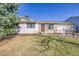 Charming single-story home featuring brick accents, white siding, and a well-manicured front yard at 1342 S Andes St, Aurora, CO 80017