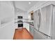 Modern kitchen with white cabinets, stainless steel appliances, black countertops and hardwood floors at 1342 S Andes St, Aurora, CO 80017
