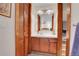 The bathroom features wood trim and a vanity with wood drawers and a sink at 4863 Silver Spruce Ln, Evergreen, CO 80439