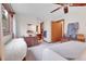 Charming bedroom featuring a ceiling fan, wood trim windows, and unique decorative elements at 4863 Silver Spruce Ln, Evergreen, CO 80439