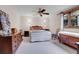 Charming bedroom featuring a ceiling fan, wood trim windows, and unique decorative elements at 4863 Silver Spruce Ln, Evergreen, CO 80439