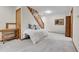 Bedroom with a bed, under-window shelving, and wooden stairway at 4863 Silver Spruce Ln, Evergreen, CO 80439