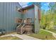 Charming multi-level home featuring a welcoming porch, with green siding, and well-maintained landscaping at 4863 Silver Spruce Ln, Evergreen, CO 80439