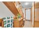 Well lit foyer featuring a wooden staircase, tile floor, and convenient access to the entry door and other rooms at 4863 Silver Spruce Ln, Evergreen, CO 80439
