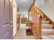Inviting foyer with tile flooring, wooden staircase, and decor that provide a warm and welcoming atmosphere at 4863 Silver Spruce Ln, Evergreen, CO 80439