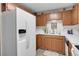 Modern kitchen featuring white appliances, wooden cabinetry, and ample countertop space at 4863 Silver Spruce Ln, Evergreen, CO 80439