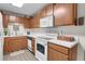 Well-equipped kitchen featuring white appliances, wooden cabinetry, and plenty of counter space for meal preparation at 4863 Silver Spruce Ln, Evergreen, CO 80439