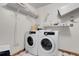 Laundry room with full-size washer and dryer, utility sink and shelving at 4863 Silver Spruce Ln, Evergreen, CO 80439