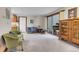 Cozy living room with neutral carpet, ample seating, sliding glass door leading to balcony, and wooden cabinets at 4863 Silver Spruce Ln, Evergreen, CO 80439