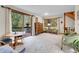 Spacious living area with a sliding glass door to the deck, large windows, and ample seating for entertaining at 4863 Silver Spruce Ln, Evergreen, CO 80439