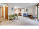 Bright living room featuring plush carpeting, comfortable seating, and an open layout connecting to the kitchen at 4863 Silver Spruce Ln, Evergreen, CO 80439