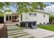 Home's backyard featuring a hot tub, grassy stepping stones and a covered patio at 260 S Jasmine St, Denver, CO 80224
