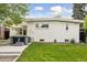 Home's backyard featuring a brick exterior, a hot tub, and a manicured lawn at 260 S Jasmine St, Denver, CO 80224