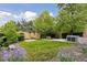 Spacious backyard showcasing lush grass, a seating area, a hot tub and beautiful landscaping at 260 S Jasmine St, Denver, CO 80224