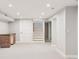 Spacious finished basement area with new carpet, recessed lighting, and a wet bar at 260 S Jasmine St, Denver, CO 80224