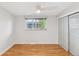 Clean and bright bedroom featuring wood floors, window and closet at 260 S Jasmine St, Denver, CO 80224