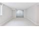 Neutral bedroom featuring light carpet, neutral walls, a window and sliding doors at 260 S Jasmine St, Denver, CO 80224