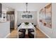 Bright dining room featuring a modern light fixture, stylish art, and views of the backyard at 260 S Jasmine St, Denver, CO 80224
