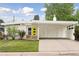 Charming mid-century modern home featuring a bright, eye-catching front door and covered carport at 260 S Jasmine St, Denver, CO 80224