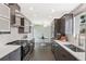 Modern kitchen with stainless steel appliances, sleek cabinetry, and an adjacent casual dining area at 260 S Jasmine St, Denver, CO 80224