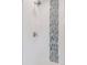 Sleek shower featuring white tiles and a decorative mosaic accent stripe at 260 S Jasmine St, Denver, CO 80224