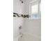 Clean bathroom with white tile, contrasting tile accent, and shower/tub combo at 260 S Jasmine St, Denver, CO 80224