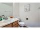 Cozy half bathroom with wood cabinets, neutral paint, and modern fixtures at 6839 Zenobia St # 3, Westminster, CO 80030