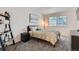 Well lit bedroom featuring carpeted floors, neutral paint, and modern lamps at 6839 Zenobia St # 3, Westminster, CO 80030