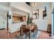 Inviting dining area with wood floors and view into kitchen with modern fixtures and ample counter space at 6839 Zenobia St # 3, Westminster, CO 80030
