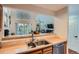Open kitchen with breakfast bar overlooking the living area, stainless steel sink and appliances at 6839 Zenobia St # 3, Westminster, CO 80030