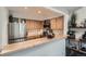 Well-lit kitchen with stainless steel appliances, light wood cabinets, and a breakfast bar, perfect for casual dining at 6839 Zenobia St # 3, Westminster, CO 80030
