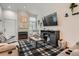 Comfortable living room with a fireplace, plush seating, and a large TV, perfect for relaxation and entertainment at 6839 Zenobia St # 3, Westminster, CO 80030