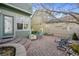 Backyard brick patio with raised seating area, mature trees, and lots of sun at 12453 Knox Ct, Broomfield, CO 80020