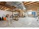 Unfinished basement with exposed ceiling, concrete floors and stairs to first floor at 12453 Knox Ct, Broomfield, CO 80020