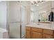 Bright bathroom features a tile shower, white countertop, and wood cabinets at 12453 Knox Ct, Broomfield, CO 80020