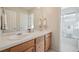 Bathroom featuring double vanity, well lit mirror and separate glass enclosed shower at 12453 Knox Ct, Broomfield, CO 80020