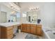 Bright bathroom features a white countertop, wood cabinets, and a large mirror at 12453 Knox Ct, Broomfield, CO 80020