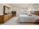 Bright bedroom features wood furnishings, soft carpet, and a large window for natural light at 12453 Knox Ct, Broomfield, CO 80020