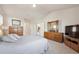 Bright bedroom features a light gray comforter, vaulted ceiling and wood furnishings at 12453 Knox Ct, Broomfield, CO 80020