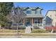 Charming two-story home with brick and siding, a covered porch, and manicured landscaping at 12453 Knox Ct, Broomfield, CO 80020