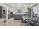 A kitchen featuring stainless appliances, an island, and a small eating area, with white and gray cabinetry at 12453 Knox Ct, Broomfield, CO 80020