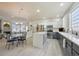 Bright eat-in kitchen featuring stainless steel appliances, white countertops, and a decorative glass block window at 12453 Knox Ct, Broomfield, CO 80020