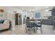 Bright kitchen with stainless appliances, a glass table, and a large window featuring a unique glass block design at 12453 Knox Ct, Broomfield, CO 80020