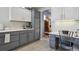 A counter area of a kitchen with a small desk area featuring a white and gray color scheme at 12453 Knox Ct, Broomfield, CO 80020