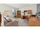 A loft featuring carpet flooring, a comfortable couch, and a wooden desk/bookcase unit at 12453 Knox Ct, Broomfield, CO 80020