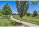 Scenic view of the neighborhood, featuring walking paths, mature trees, and green spaces at 12453 Knox Ct, Broomfield, CO 80020